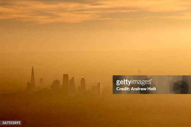 aerial view south across the city of london in fog and or air pollution - luftverschmutzung stock-fotos und bilder