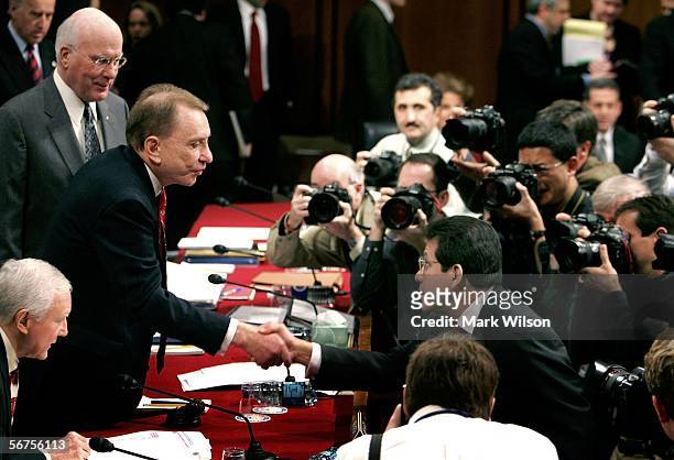 Senate Judiciary Committee Chairman Arlen Specter shakes hands with Attorney General Alberto Gonzales as U.S. Sen. Patrick Leahy looks on before the...
