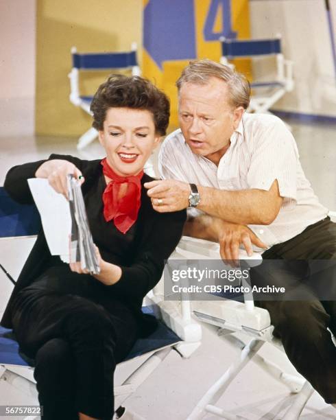 American actress Judy Garland shows a script to actor Mickey Rooney, her guest star on an episode of 'The Judy Garland Show,' as the pair rehearse...