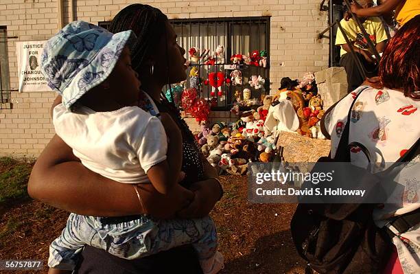 Residents mill around an impromptu memorial for SE DC resident Charquisa Johnson, a young mother of two children who was shot by a police officer May...