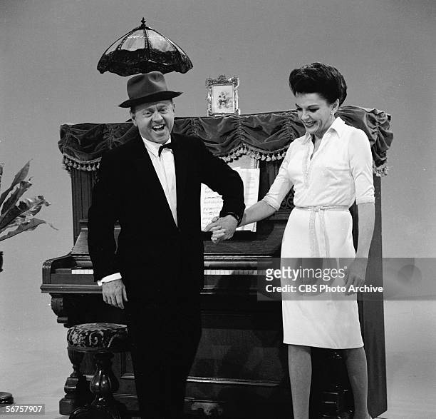 American actors Mickey Rooney and Judy Garland hold hands on the set of 'The Judy Garland Show.' December 8, 1963.