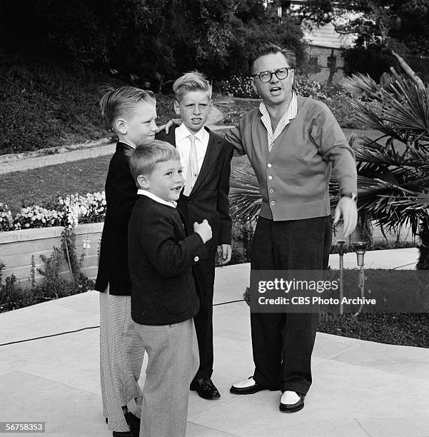 American actor Mickey Rooney poses with his children, Teddy , Tim, and Mickey Jr., on an episode of the Edward R. Murrow-hosted interview show...