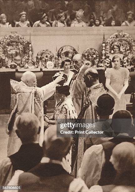 'The moment of the crowning of Queen Elizabeth, the wife of King George VI, at the coronation at Westminster Abbey', 1937. From The Coronation of...