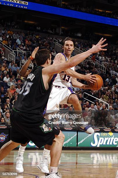 Steve Nash of the Phoenix Suns looks to pass around Mark Madsen of the Minnesota Timberwolves in an NBA game played on February 6 at U.S. Airways...