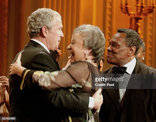 The U.S. President George W. Bush dances with a guest as Arthur Mitchell, Founder and Artistic Director of the Dance Theatre of Harlem looks on...