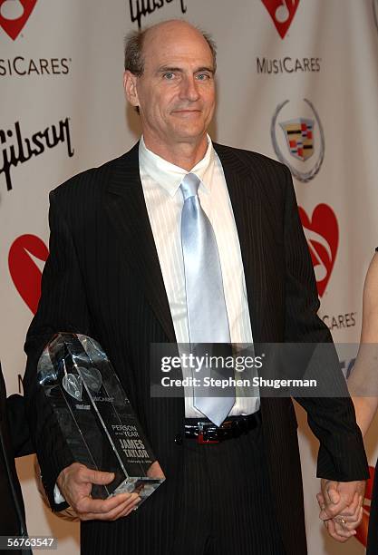 Musician James Taylor with his award poses as he arrives at the 2006 MusiCares Person of the Year honoring James Taylor at the Los Angeles Convention...