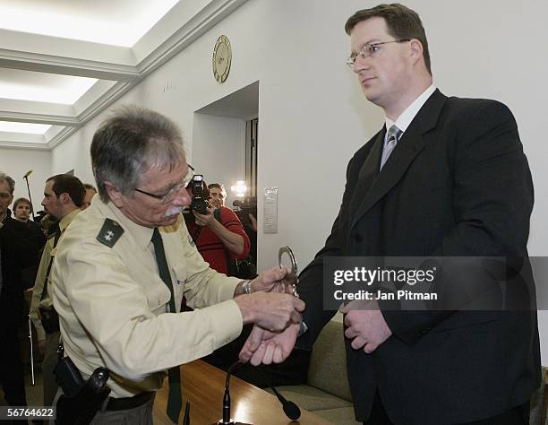 Police officer takes off the handcuffs of Stephan L. In a court room at the beginning of his trial on February 7, 2006 in Kempten, Germany. 27 years...