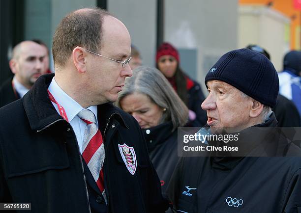 Prince Albert of Monaco talks to former I.O.C President Juan Antonio Samaranch as they visit the athlete's Olympic village during the Turin 2006...