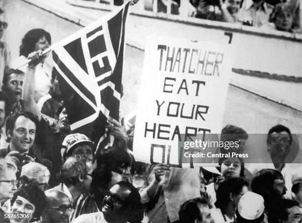 British sports fans at the Moscow Olympics with a placard reading 'Thatcher Eat Yout Heart Out', 6th August 1980. The British government, under Prime...