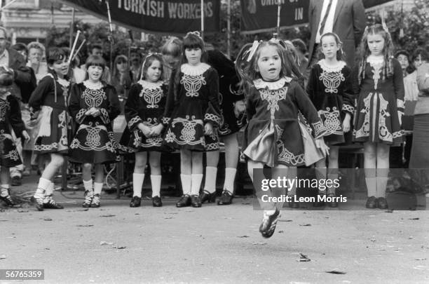 Group of little girls perform an Irish dance in tradiational costumes, circa 1985.