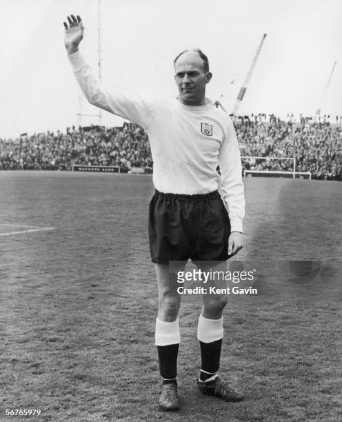 Fulham centre-half Eddie Lowe waves farewell at the start of his last match in league football, 4th May 1963. In honour of the occasion, Lowe was...