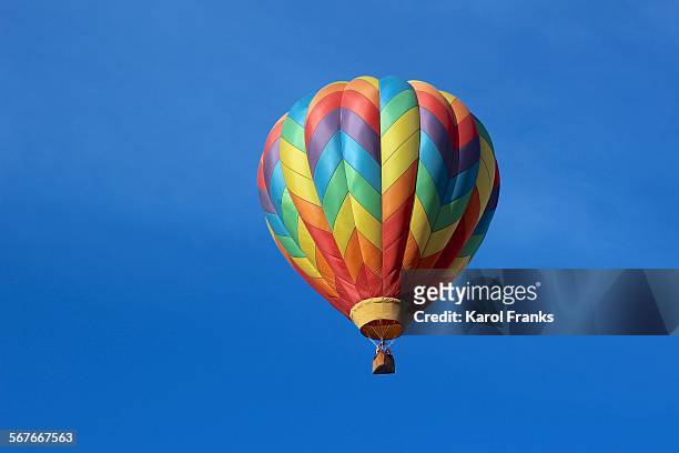 sailing rainbow colored hot air balloon - hot air balloon ride stock pictures, royalty-free photos & images