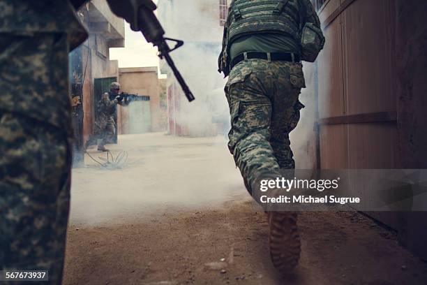 army troops advance a position in combat. - conflict fotografías e imágenes de stock