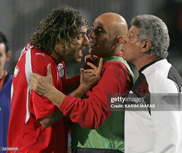 Egypt star striker Ahmed "Mido" Hossam , player in Tottenham , argues with Egyptian coach Hassan Shehata after he was taken out from the field during...