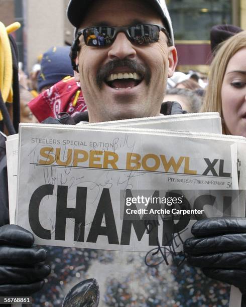 Pittsburgh Steelers fan holds a newspaper with autographs during the victory parade celebrating winning Super Bowl XL February 7, 2006 in downtown...