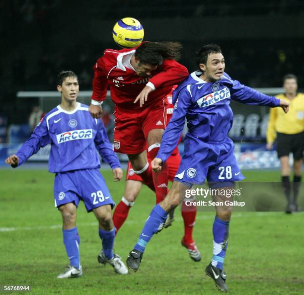 Martin Demichelis of FC Bayern Munich fights for the ball against Malik Fathi and Sofian Chahed of Hetha BSC compete for the ball during the...