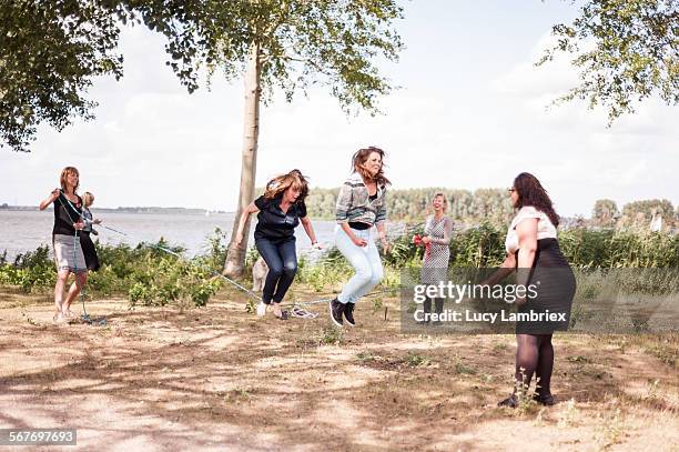 Women jumping rope by the water