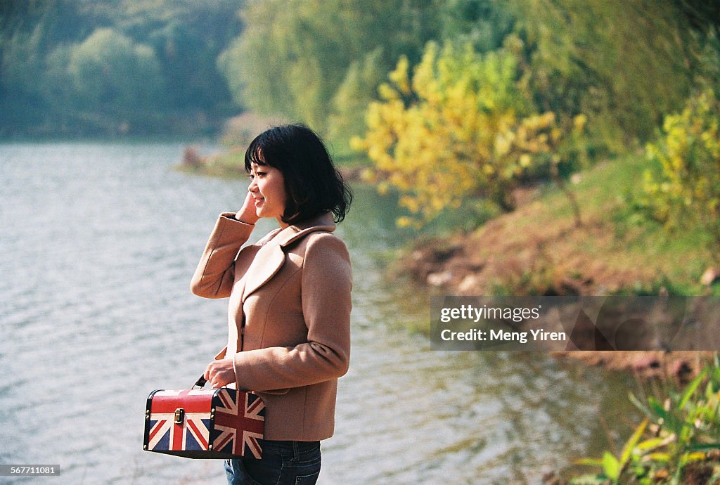 Young woman beside lake