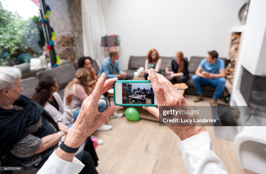 Woman photographing her family