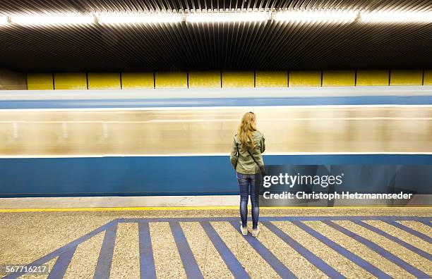 waiting on her train - plataforma de estação de metro imagens e fotografias de stock