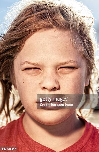 teenage boy squinting. - child eyes closed stock pictures, royalty-free photos & images