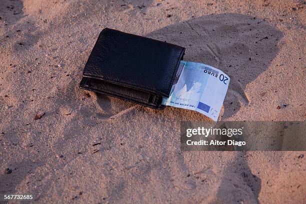 wallet on the sand with 20 note. - twenty euro banknote stock pictures, royalty-free photos & images