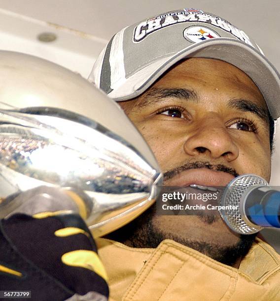 Pittsburgh Steelers fans are reflected in the Vince Lombardi Trophy as Jerome Bettis speaks to the crowd following the parade in downtown celebrating...