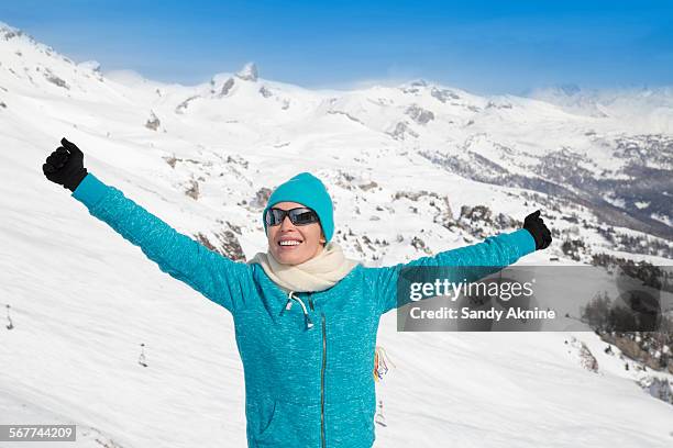 happy beautiful woman enjoying in snow, crans-montana, swiss alps, switzerland - crans montana - fotografias e filmes do acervo