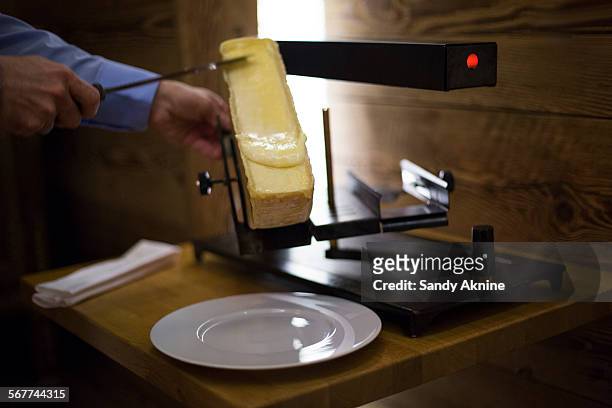 raclette cheese on grill, crans-montana, swiss alps, switzerland - cantòn vallese foto e immagini stock