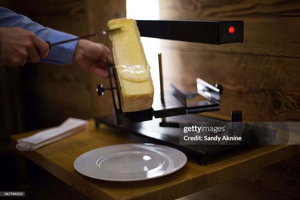 Raclette cheese on grill, Crans-Montana, Swiss Alps, Switzerland