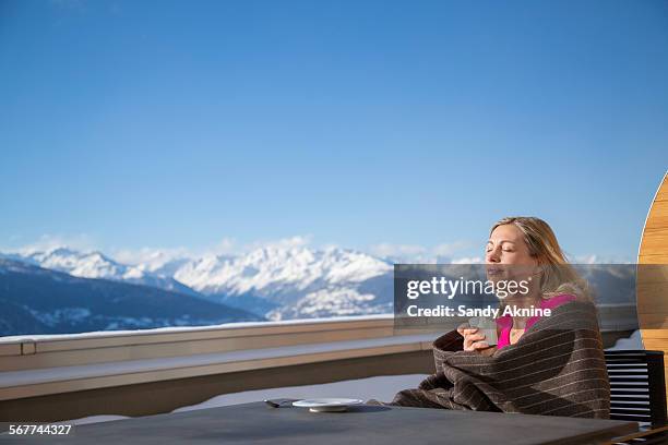 woman drinking coffee, crans-montana, swiss alps, switzerland - crans montana - fotografias e filmes do acervo