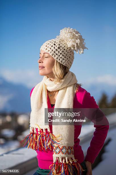 beautiful woman day dreaming, crans-montana, swiss alps, switzerland - headwear stockfoto's en -beelden