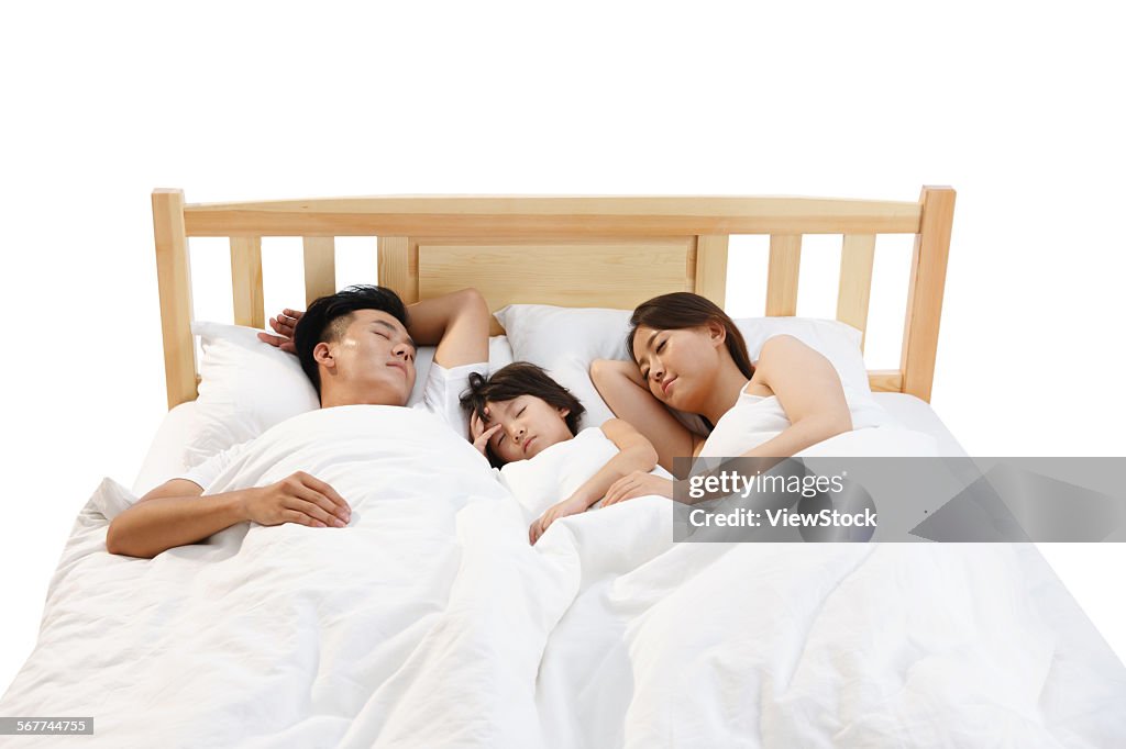 The happiness of a family of three in a bed