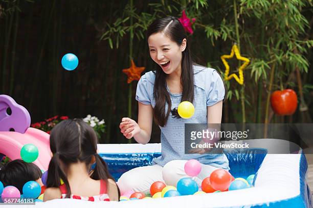 kindergarten children and teachers play outdoors - adult ball pit stock pictures, royalty-free photos & images