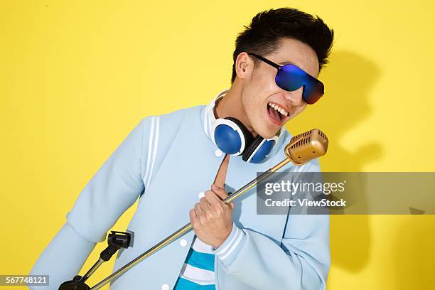 fashionable young men are singing - asian singer stock pictures, royalty-free photos & images