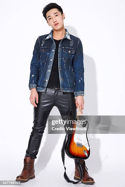 fashionable young man with a guitar - rock star stock pictures, royalty-free photos & images