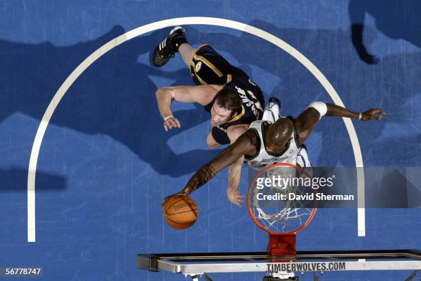 Kevin Garnett of the Minnesota Timberwolves takes the ball to the basket against Austin Croshere of the Indiana Pacers during a game at Target Center...