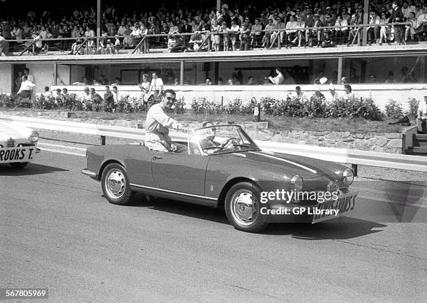 Stuart Lewis-Evans sitting on the back of an Alfa Romeo Giulietta Spider in the parade at Spa Francorchamps, Belgium, 1958.