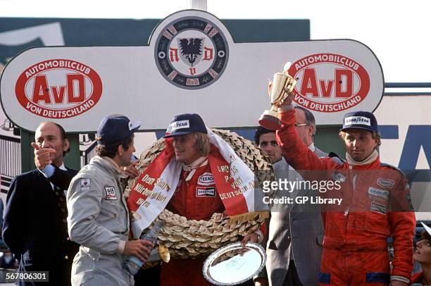 Winner James Hunt is talking with 2nd placed Jody Scheckter and German favourite Jochen Mass of McLaren finished 3rd. Niki Lauda has been burned in...