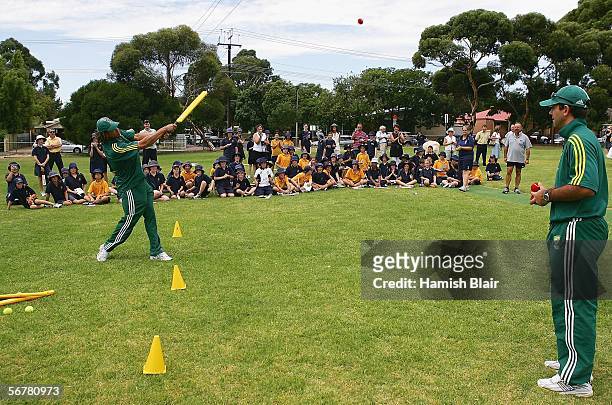 Andrew Symonds hits a ball with students and Ricky Ponting looking on during a "Back to School" program, where elite Australian cricketers visit...