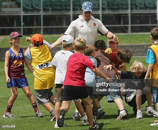 Luke Brennan of the Hawks is tackled by a group of children during the Super Clinic which is part of the Hawthorn AFL Community Camp at Aurora...