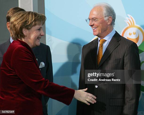 German Chancellor Angela Merkel welcomes Franz Beckenbauer during a presentation of Sport 2006 special edition stamps at the chancellery on February...