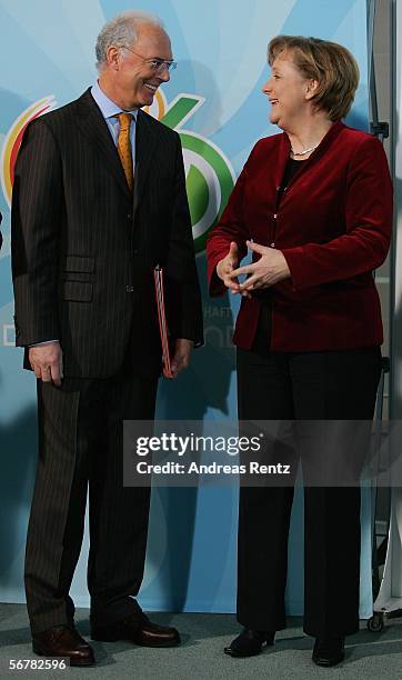 German Chancellor Angela Merkel welcomes Franz Beckenbauer during a presentation of Sport 2006 special edition stamps at the chancellery on February...