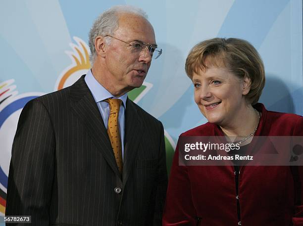 German Chancellor Angela Merkel chats with Franz Beckenbauer during a presentation of Sport 2006 special edition stamps at the chancellery on...