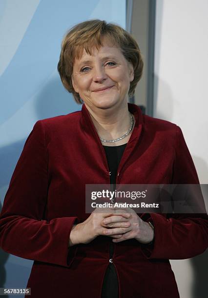 German Chancellor Angela Merkel smiles during a presentation of Sport 2006 special edition stamps and medals at the chancellery on February 8, 2006...