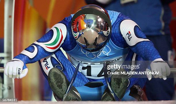 The track is refelcted in the local luge legend Armin Zoeggeler's helmet as he prepares for a training run 08 February 2006 at the 2006 Winter...