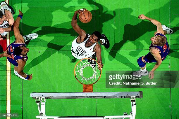 Robert Parish of the Boston Celtics grabs the rebound against Craig Ehlo of the Cleveland Cavaliers circa 1991 at the Boston Garden in Boston,...