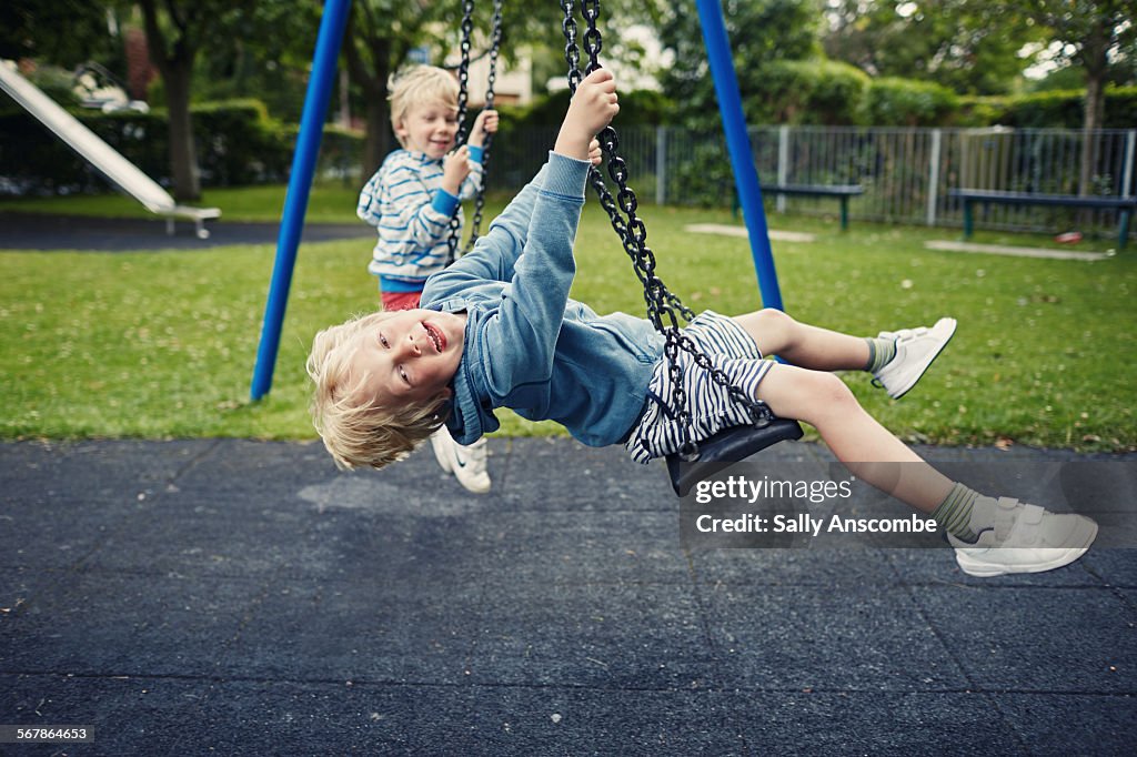 Children playing on the swings