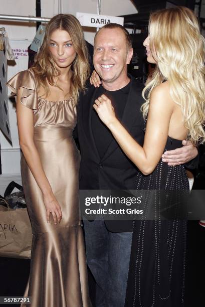 Karolina Kurkova poses with designer Michael Kors and another model backstage at the Michael Kors Fall 2006 fashion show at Bryant Park during...