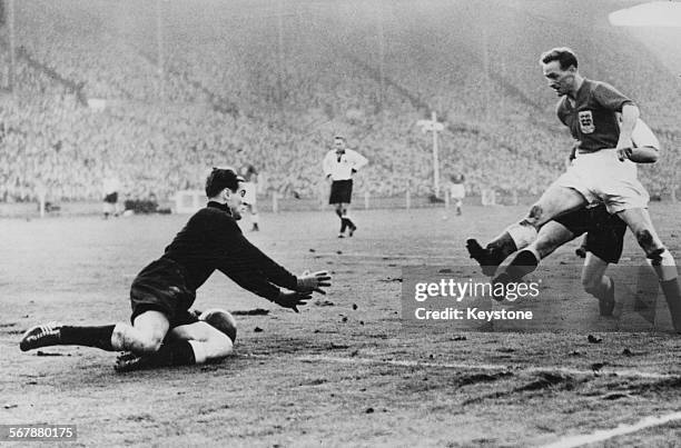 Germany goalkeeper Fritz Herkenrath reaches for the ball as Tom Finney of England rushes in during a friendly match at Wembley Stadium, London, 1st...